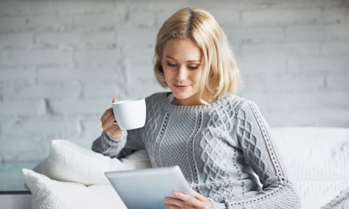 a woman petting a dog and cat