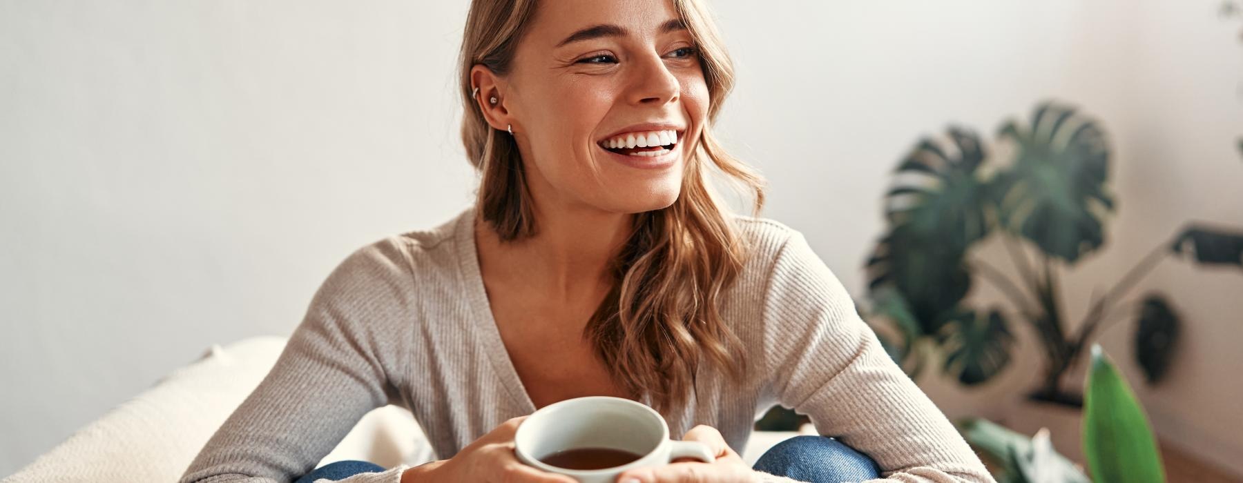 a woman holding a cup