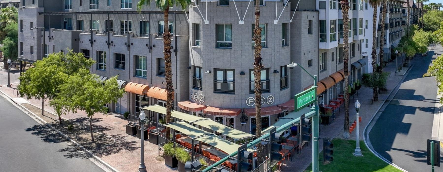 a building with palm trees and a street